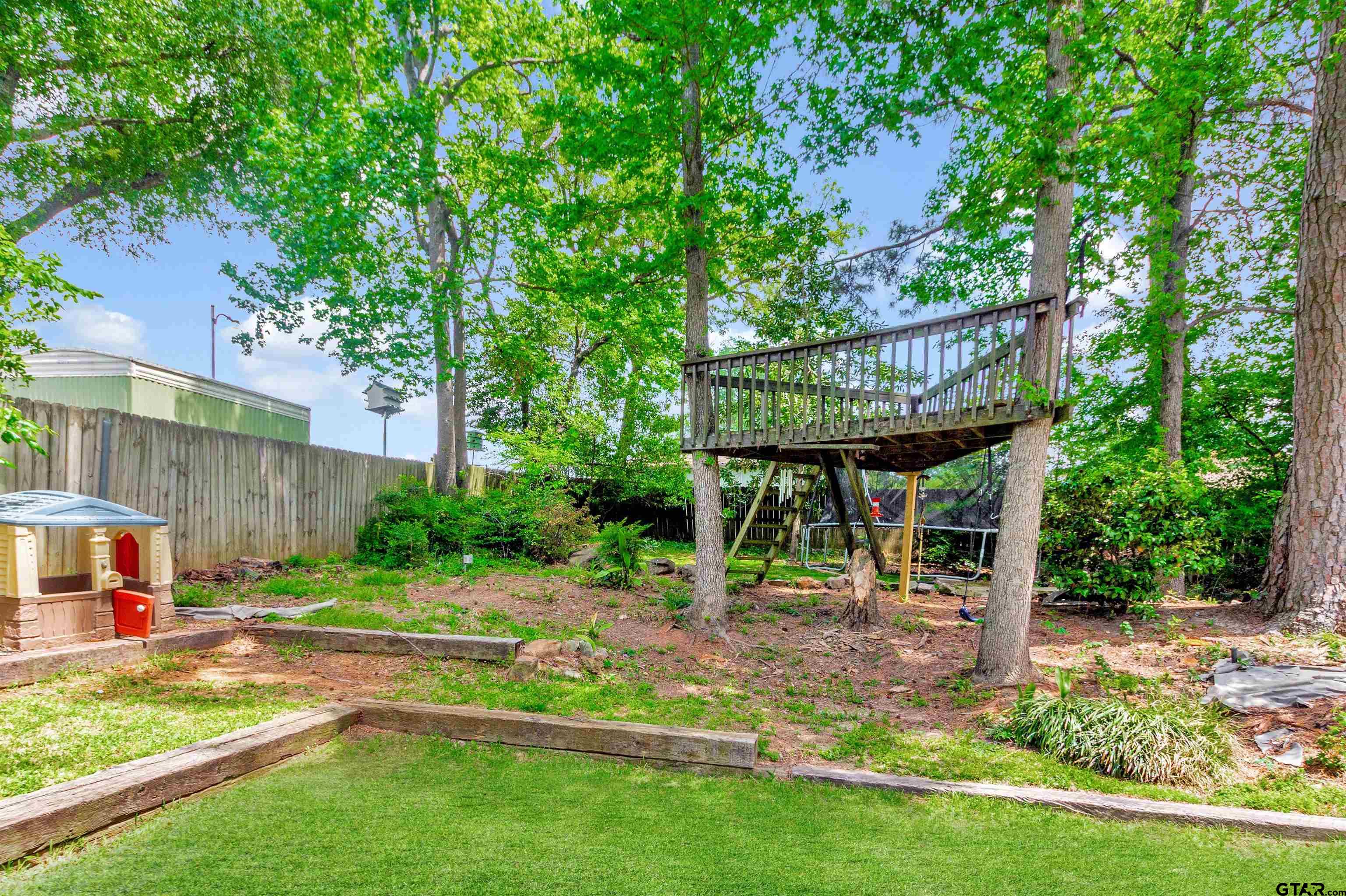 1908 Waunell Drive Tyler, TX 75701 - Photo 37 of 39 a view of backyard with table and chairs and plants