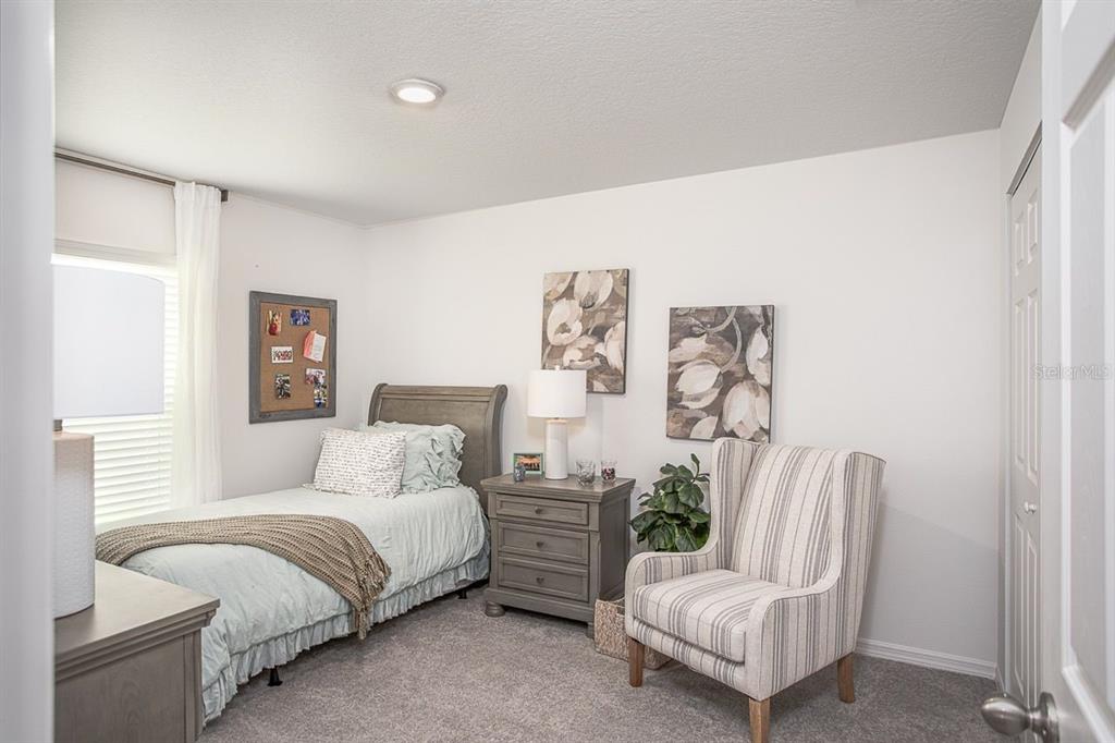 6000 East Oneida Street Inverness, FL 34452 - Photo 28 of 32 a bedroom with a bed chair and couch