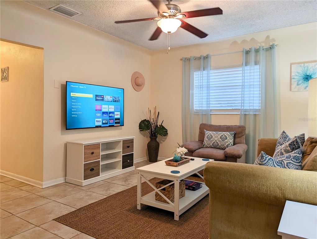 5596 100th Way North St. Petersburg, FL 33708 - Photo 40 of 67 a living room with furniture and a flat screen tv