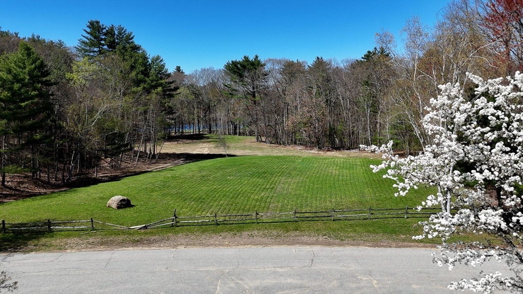 0 Wildwood Road East Brookfield, MA 01515 - Photo 6 of 38 a green field with lots of trees in the background