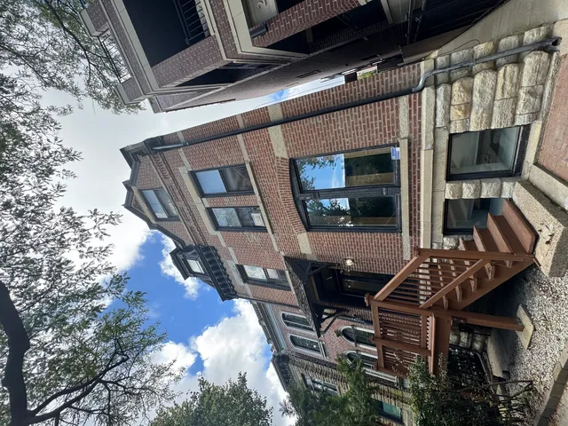 a roof deck with table and chairs