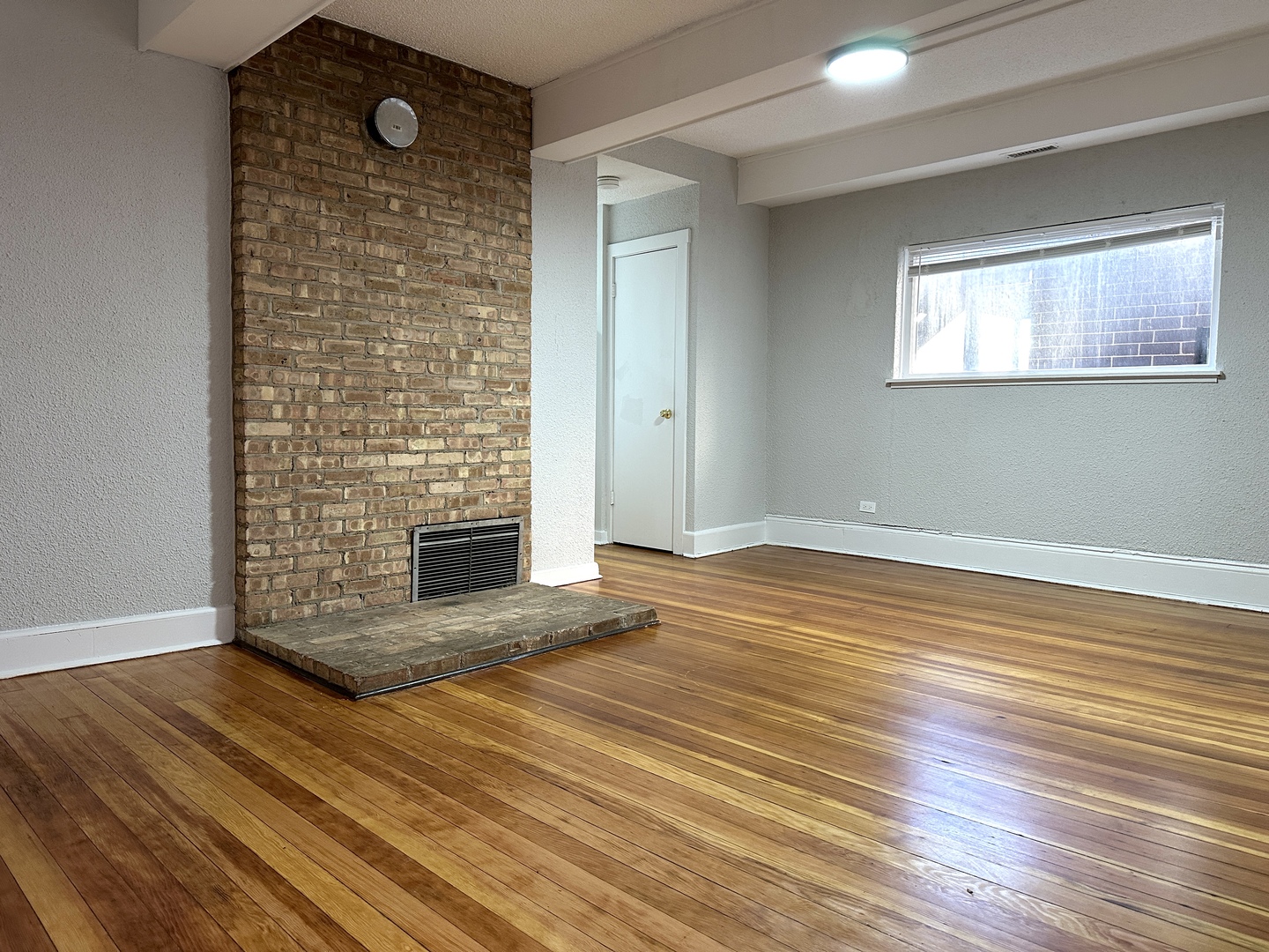 2052 North Dayton Street, Unit 2R Chicago, IL 60614 - Photo 2 of 11 a view of empty room with wooden floor and fireplace
