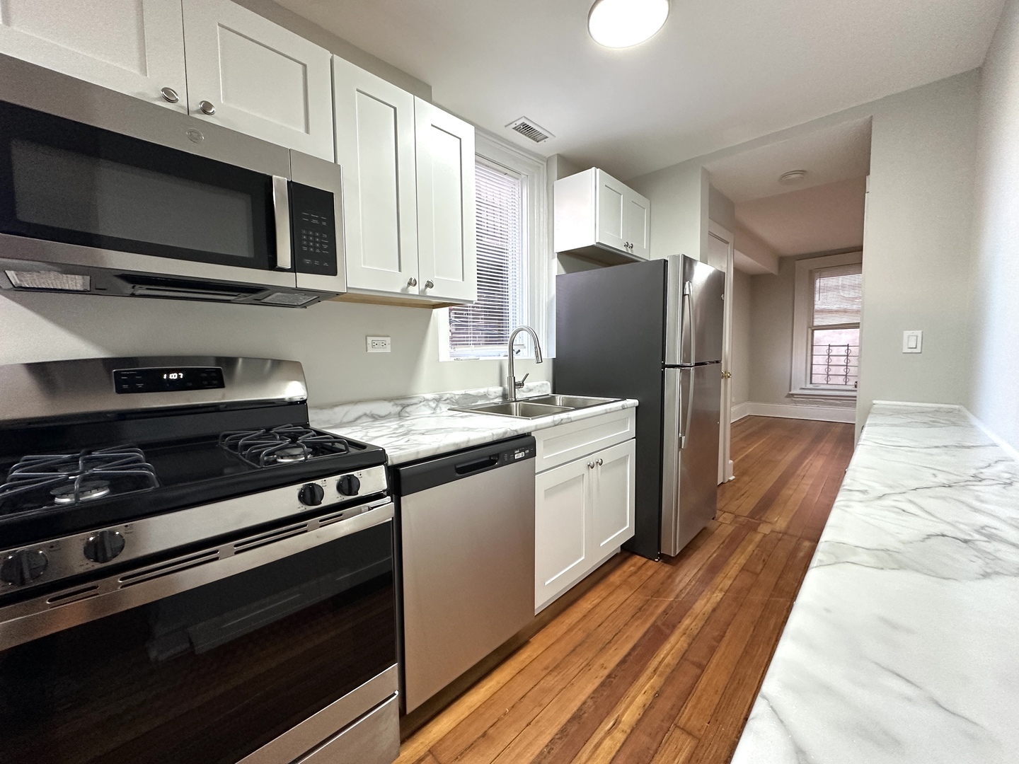 2052 North Dayton Street, Unit 2R Chicago, IL 60614 - Photo 4 of 11 a kitchen with stainless steel appliances a stove microwave and refrigerator