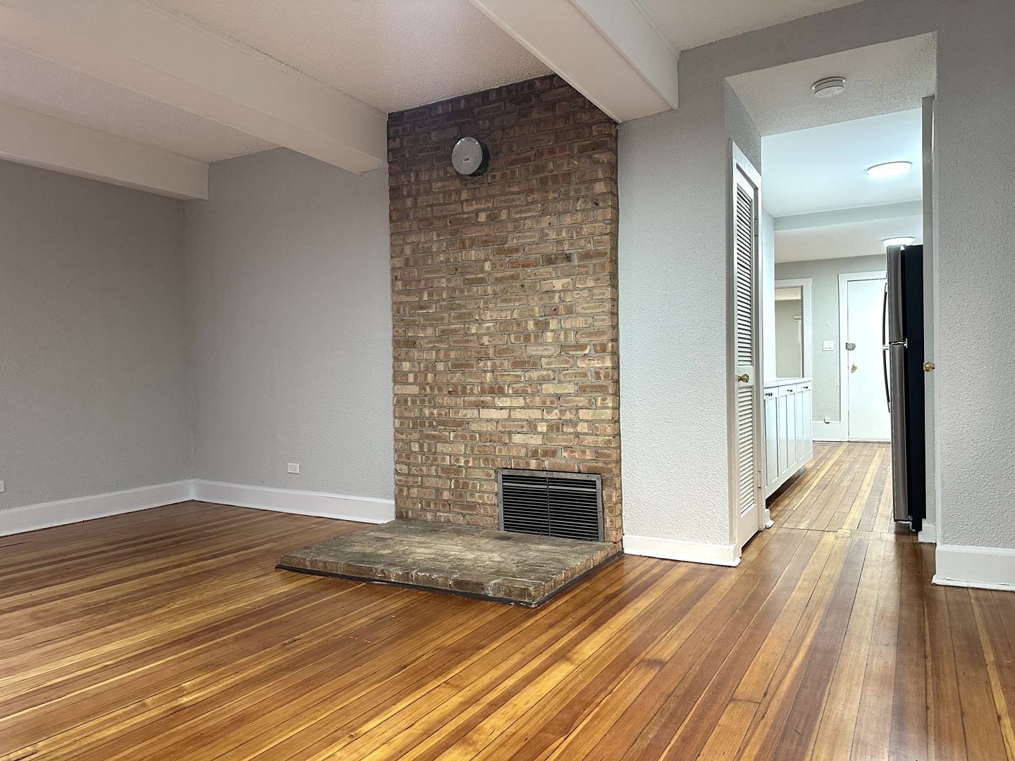 2052 North Dayton Street, Unit 2R Chicago, IL 60614 - Photo 6 of 11 wooden floor in an empty room with a fireplace