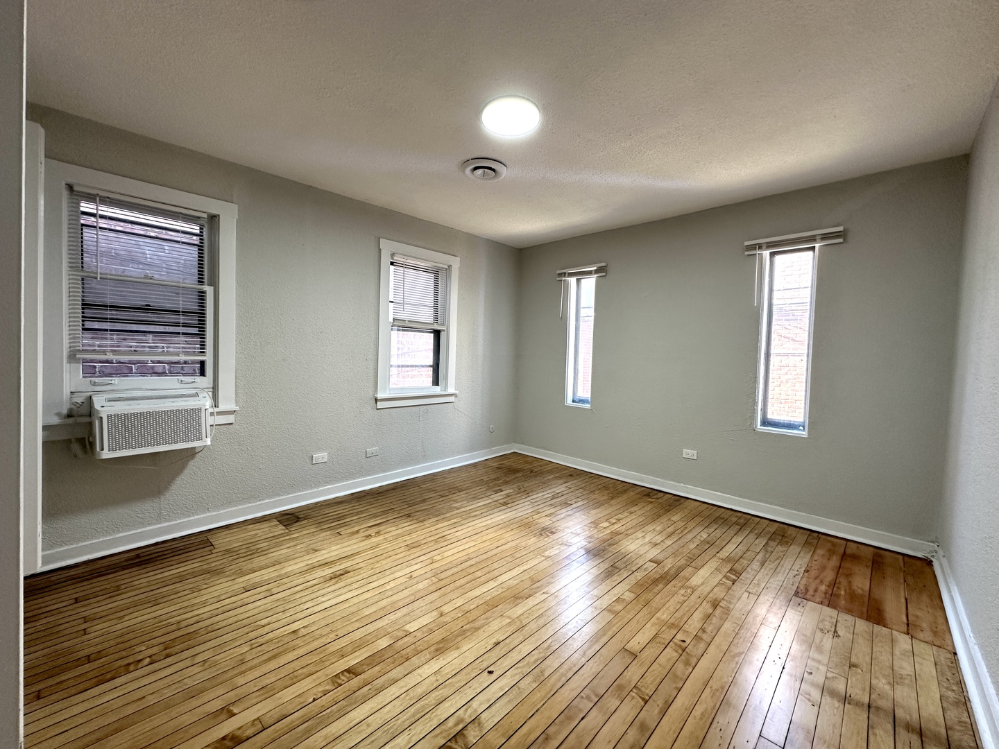 2052 North Dayton Street, Unit 2R Chicago, IL 60614 - Photo 8 of 11 a view of empty room with wooden floor and fan