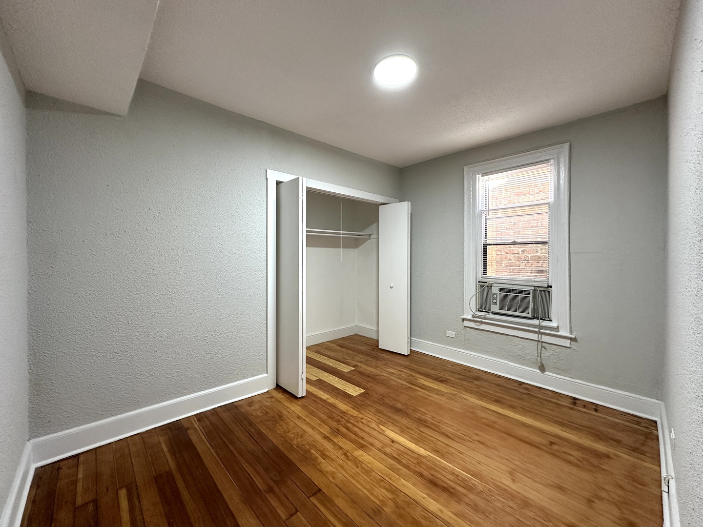 2052 North Dayton Street, Unit 2R Chicago, IL 60614 - Photo 10 of 11 a view of an empty room with wooden floor and a window