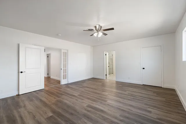 a view of an empty room with wooden floor