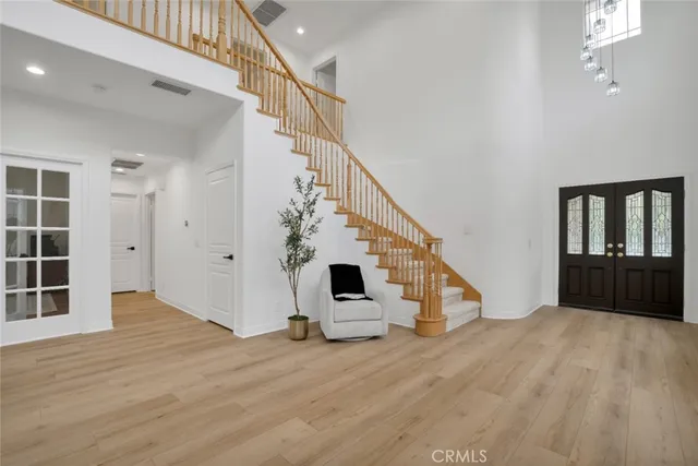 a view of entryway and hall with wooden floor