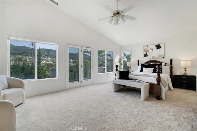 a living room with furniture and large windows