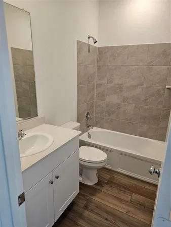a bathroom with a toilet a sink and bathtub