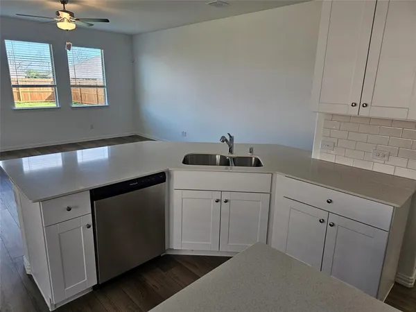 a kitchen with a sink cabinets and window