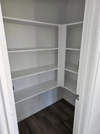 a view of walk in closet with empty racks