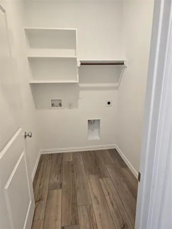 a view of a room with wooden floor and cabinet