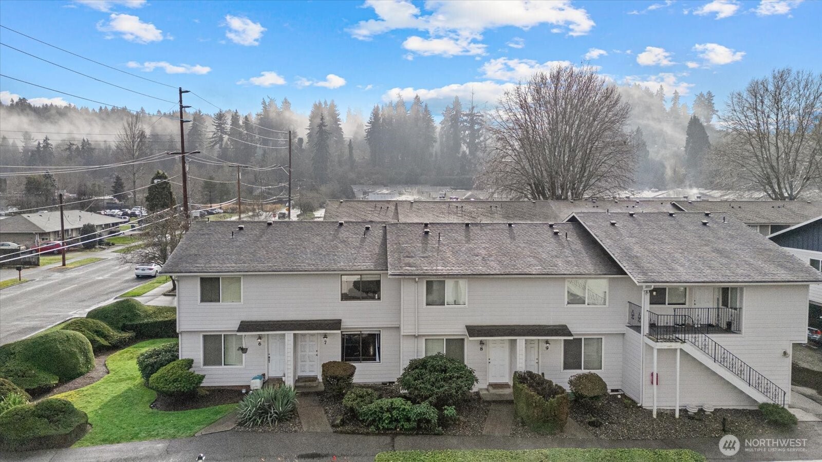 1016 9th Street Southeast, Unit 7 Puyallup, WA 98372 - Photo 24 of 25 a view of a white house next to a yard