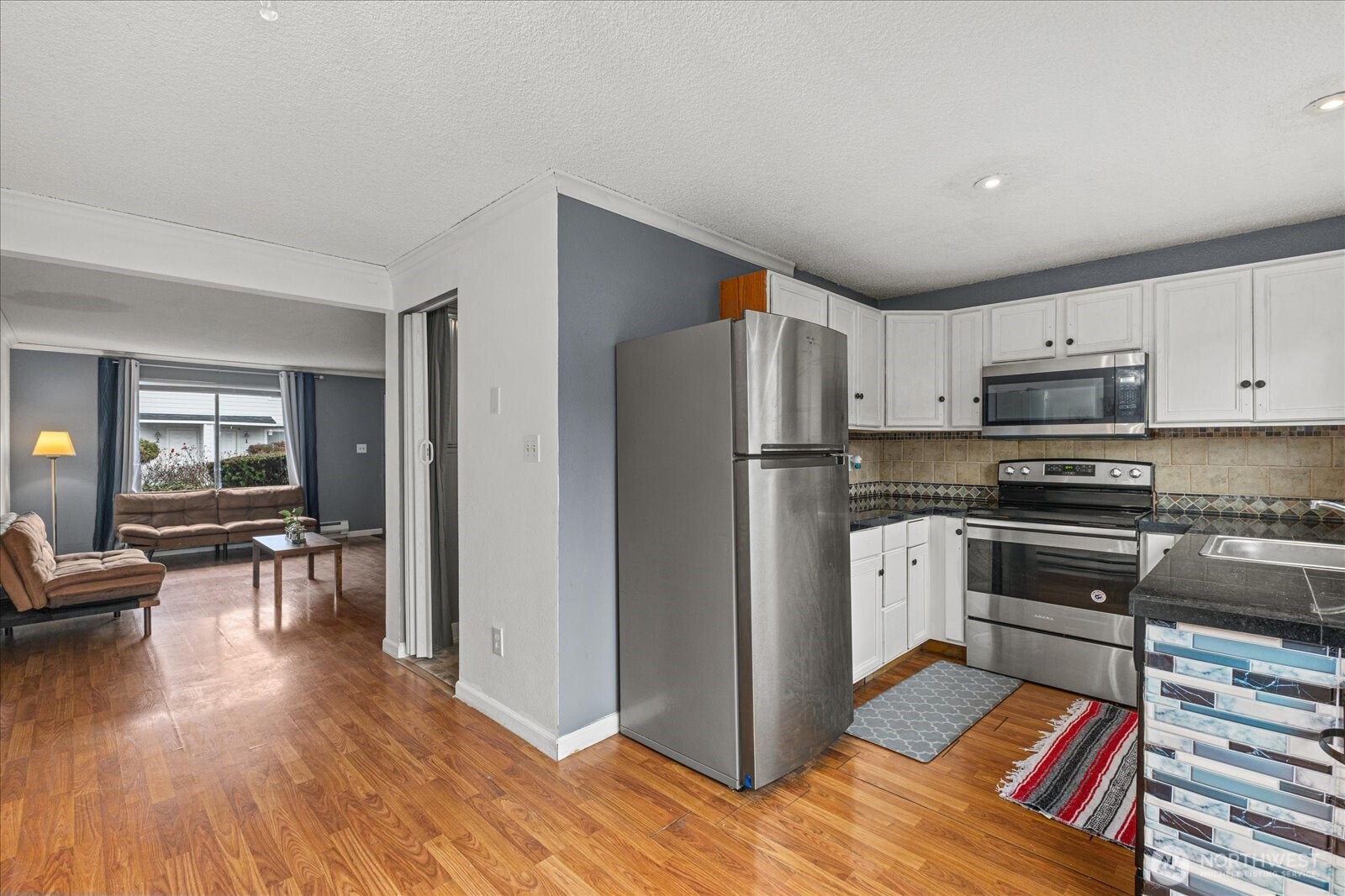 1016 9th Street Southeast, Unit 7 Puyallup, WA 98372 - Photo 7 of 29 a kitchen with stainless steel appliances granite countertop a refrigerator stove microwave and sink