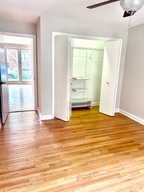 1246 West Byron Street, Unit 1 Chicago, IL 60613 - Photo 5 of 7 a view of empty room with wooden floor and window