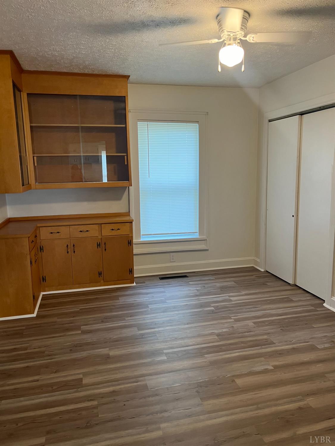1109 Amherst Avenue Altavista, VA 24517 - Photo 13 of 23 a view of an empty room with wooden floor and a window