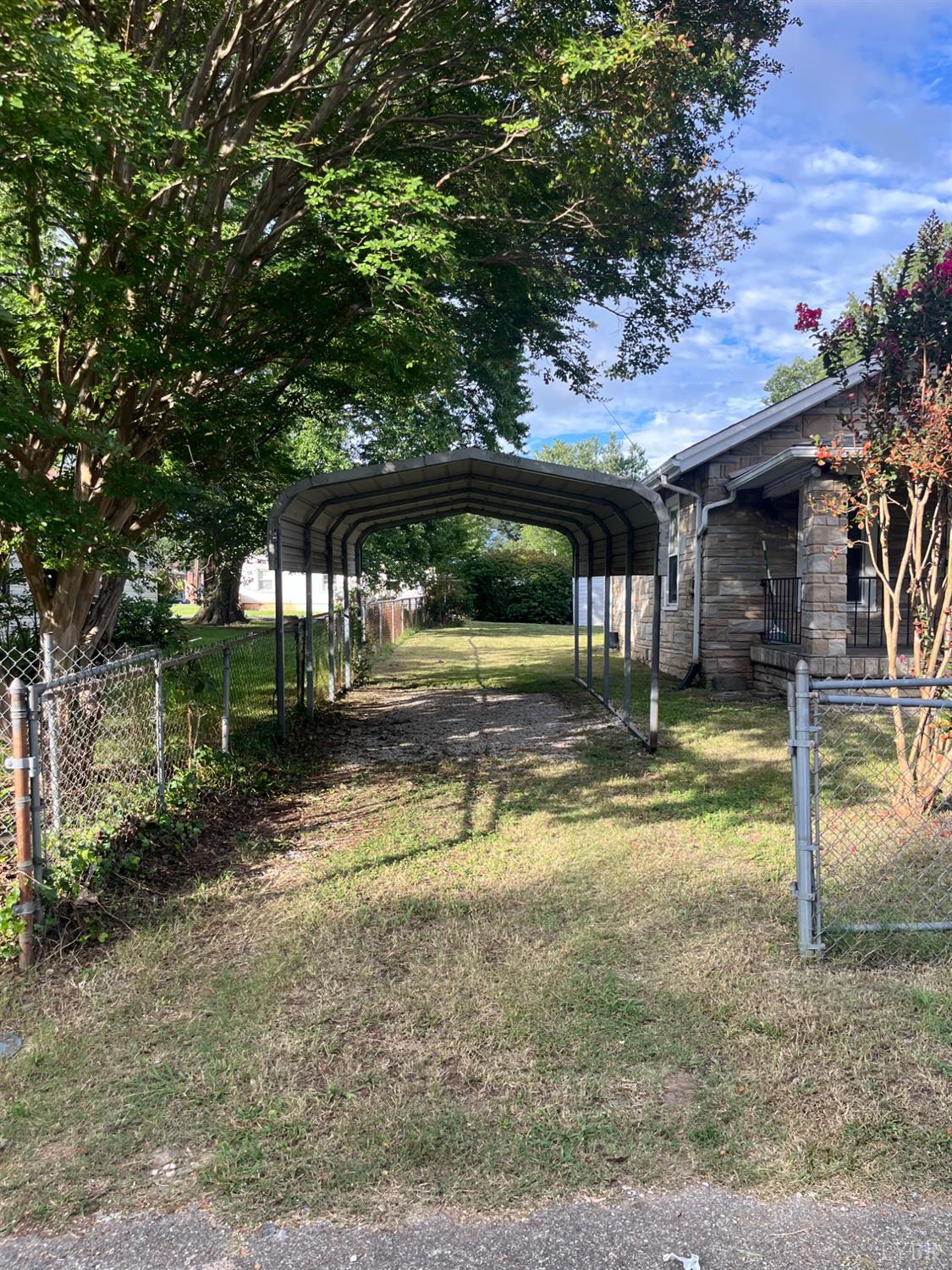 1109 Amherst Avenue Altavista, VA 24517 - Photo 20 of 23 a view of a yard with table and chairs under an umbrella