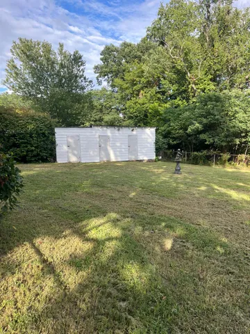 a view of a field with an trees