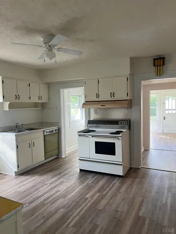 a kitchen with stainless steel appliances a stove top oven and cabinets