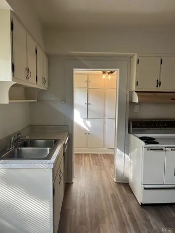 a kitchen that has a sink and a stove