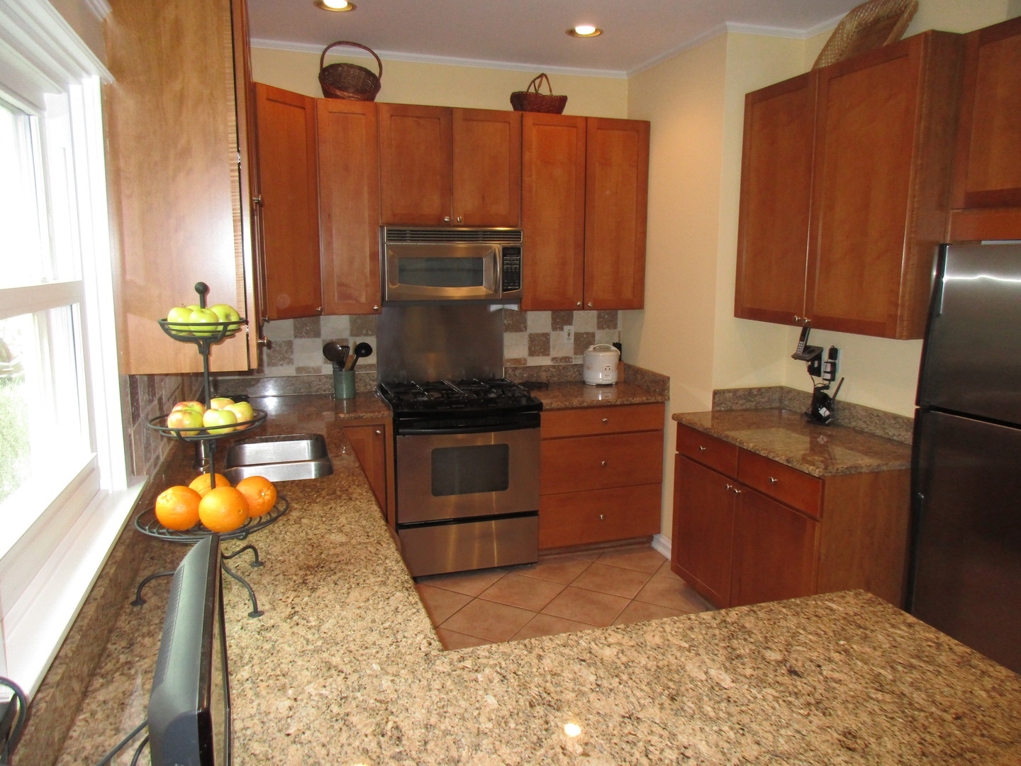 317 Shenstone Road Riverside, IL 60546 - Photo 11 of 21 a kitchen with stainless steel appliances granite countertop a stove refrigerator sink and microwave