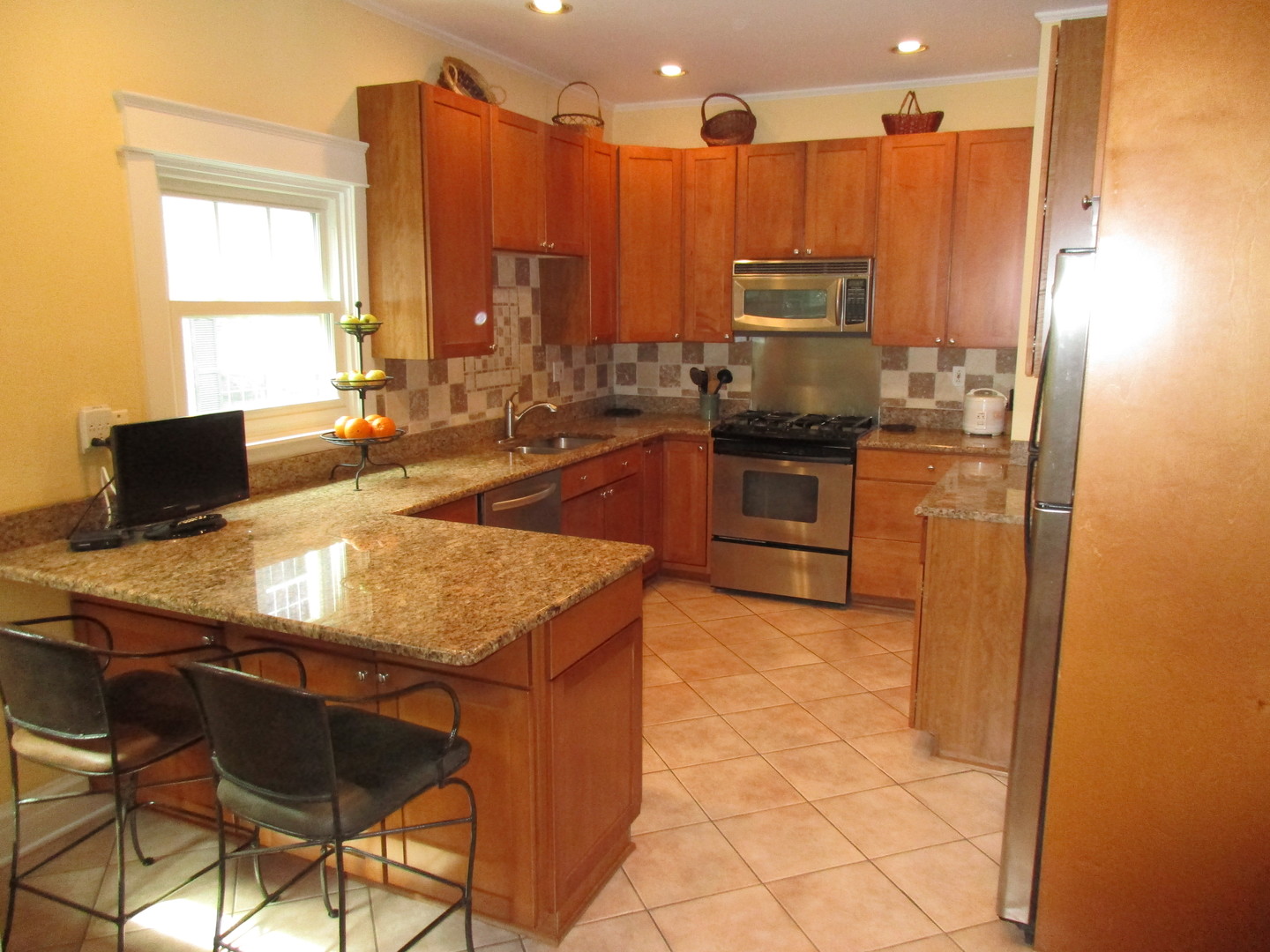317 Shenstone Road Riverside, IL 60546 - Photo 12 of 21 a kitchen with stainless steel appliances granite countertop a sink refrigerator and microwave