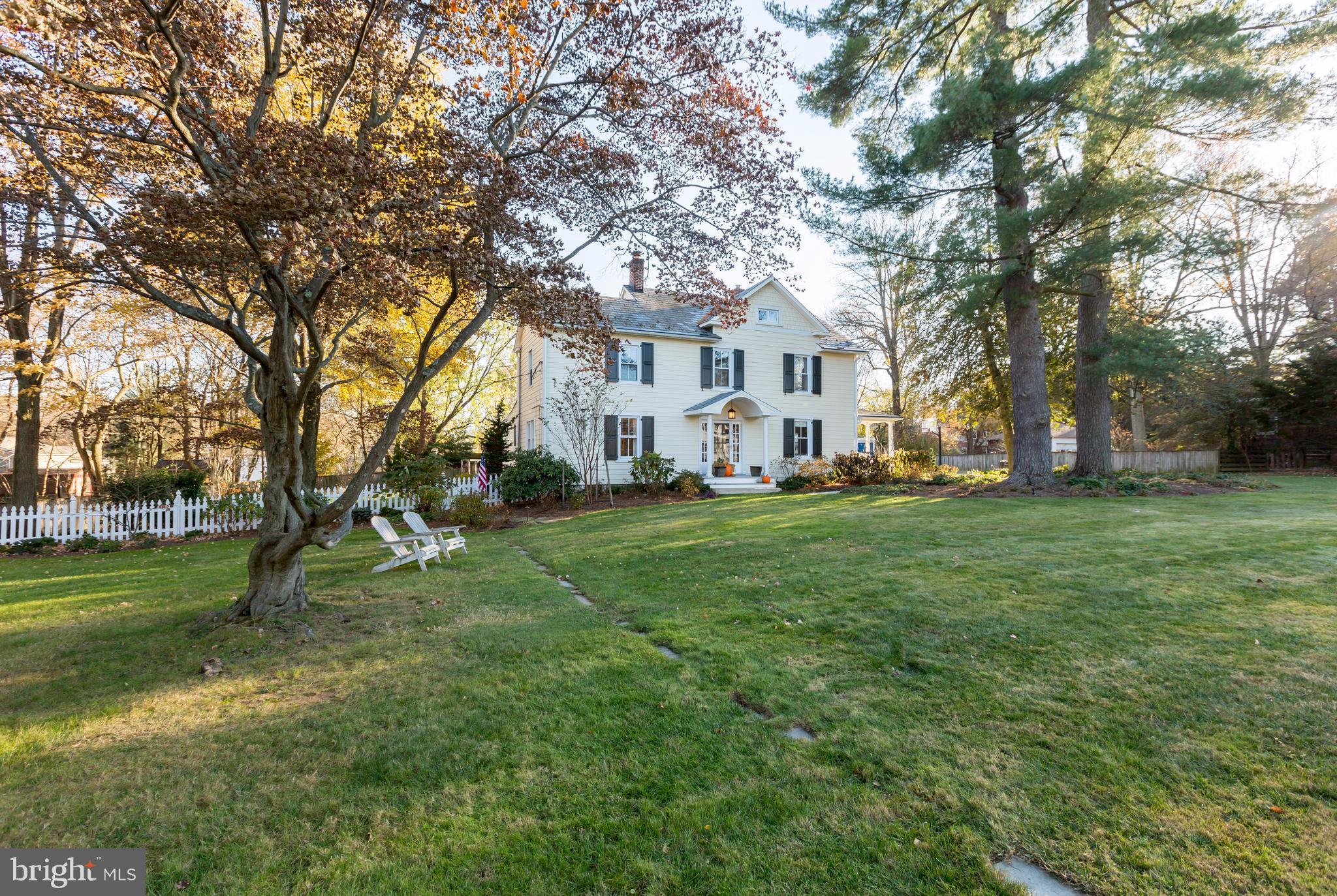 1405 Ridge Road Baltimore, MD 21228 - Photo 2 of 30 a view of a white house in front of a big yard with large trees