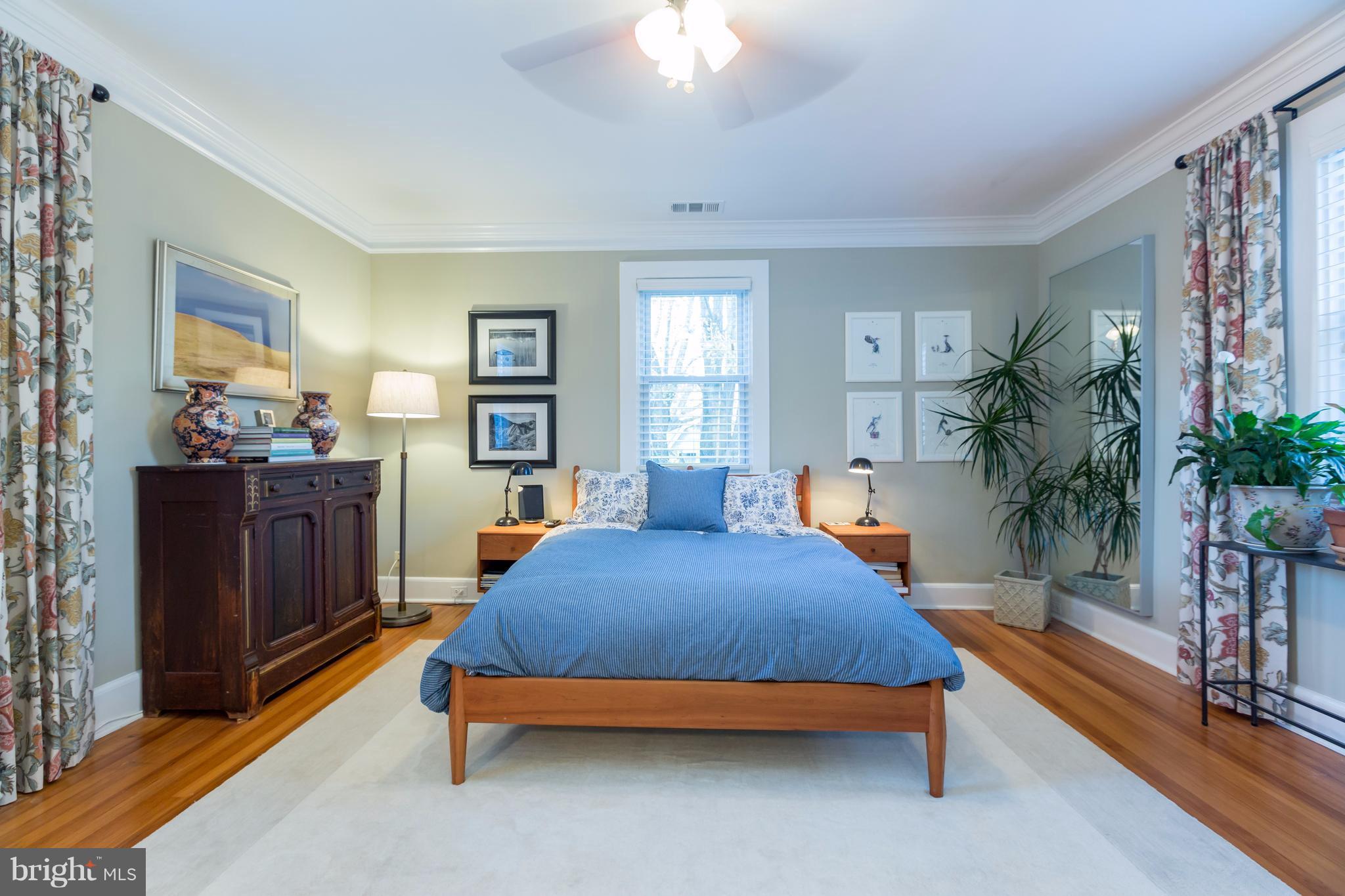 1405 Ridge Road Baltimore, MD 21228 - Photo 18 of 30 a bedroom with a bed and a chandelier
