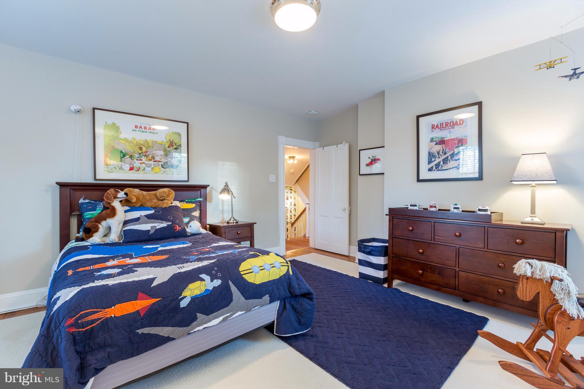 1405 Ridge Road Baltimore, MD 21228 - Photo 21 of 30 a bedroom with a bed and a lamp on dresser