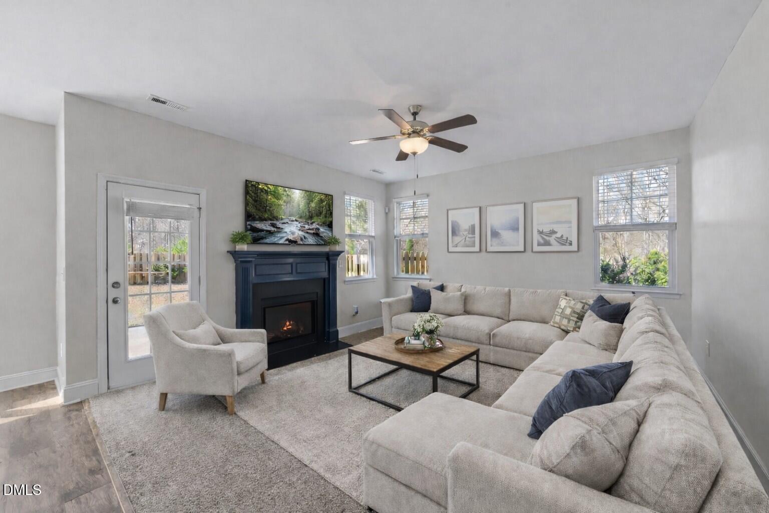 41 Solstice Lane Garner, NC 27529 - Photo 10 of 33 a living room with furniture a fireplace and a flat screen tv