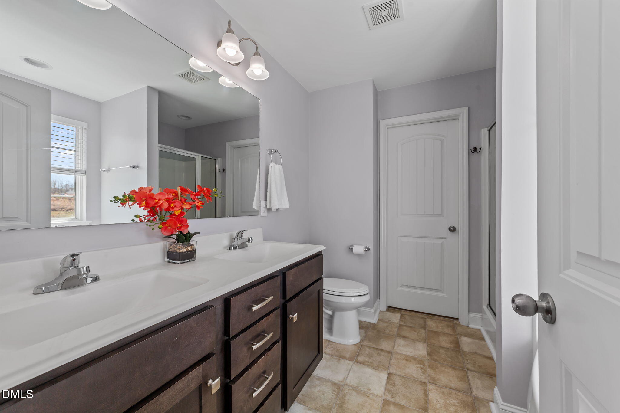 41 Solstice Lane Garner, NC 27529 - Photo 14 of 33 a bathroom with a double vanity sink mirror and toilet