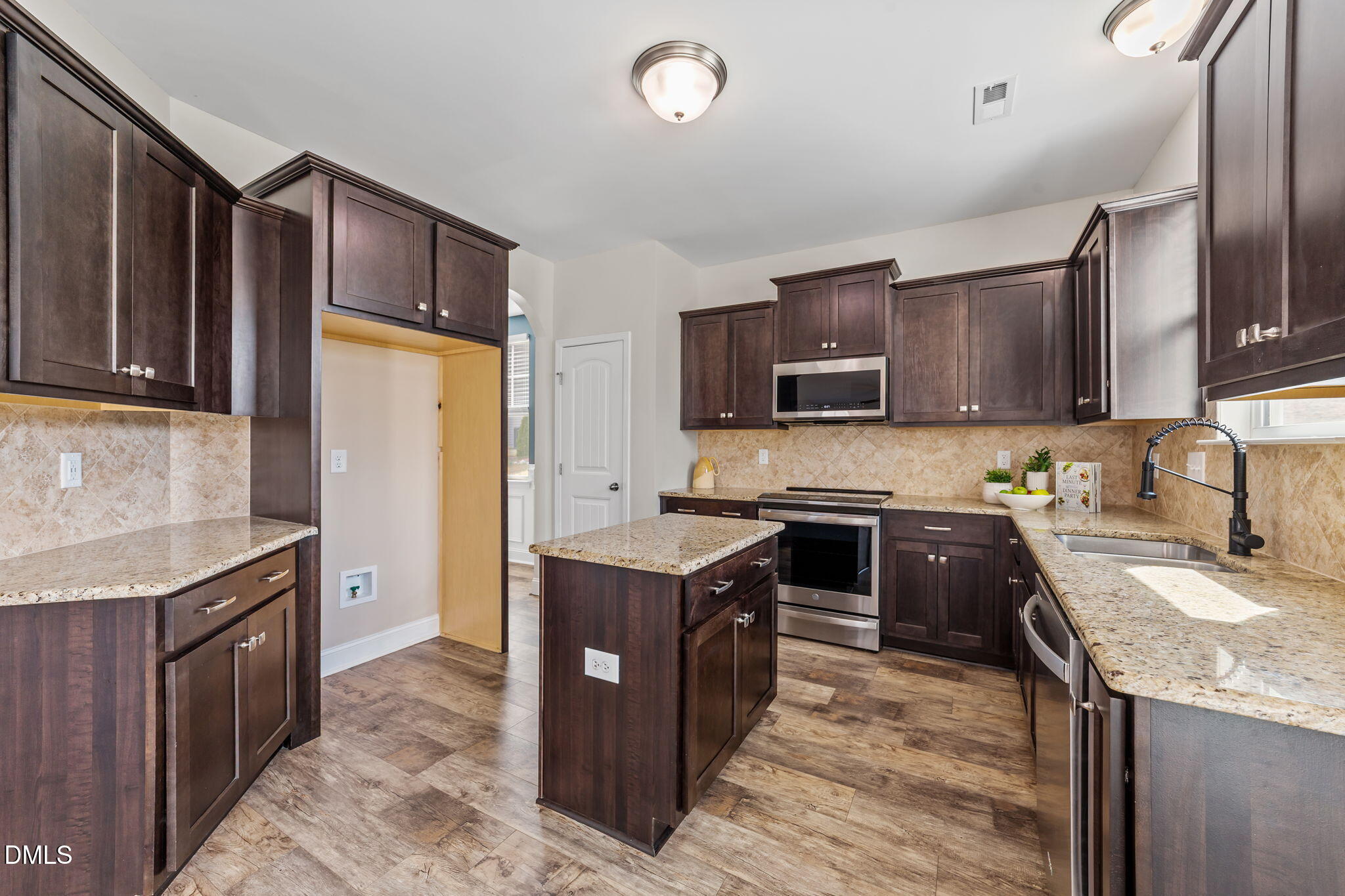 41 Solstice Lane Garner, NC 27529 - Photo 7 of 33 a kitchen with stainless steel appliances granite countertop wooden cabinets a stove top oven a sink and dishwasher