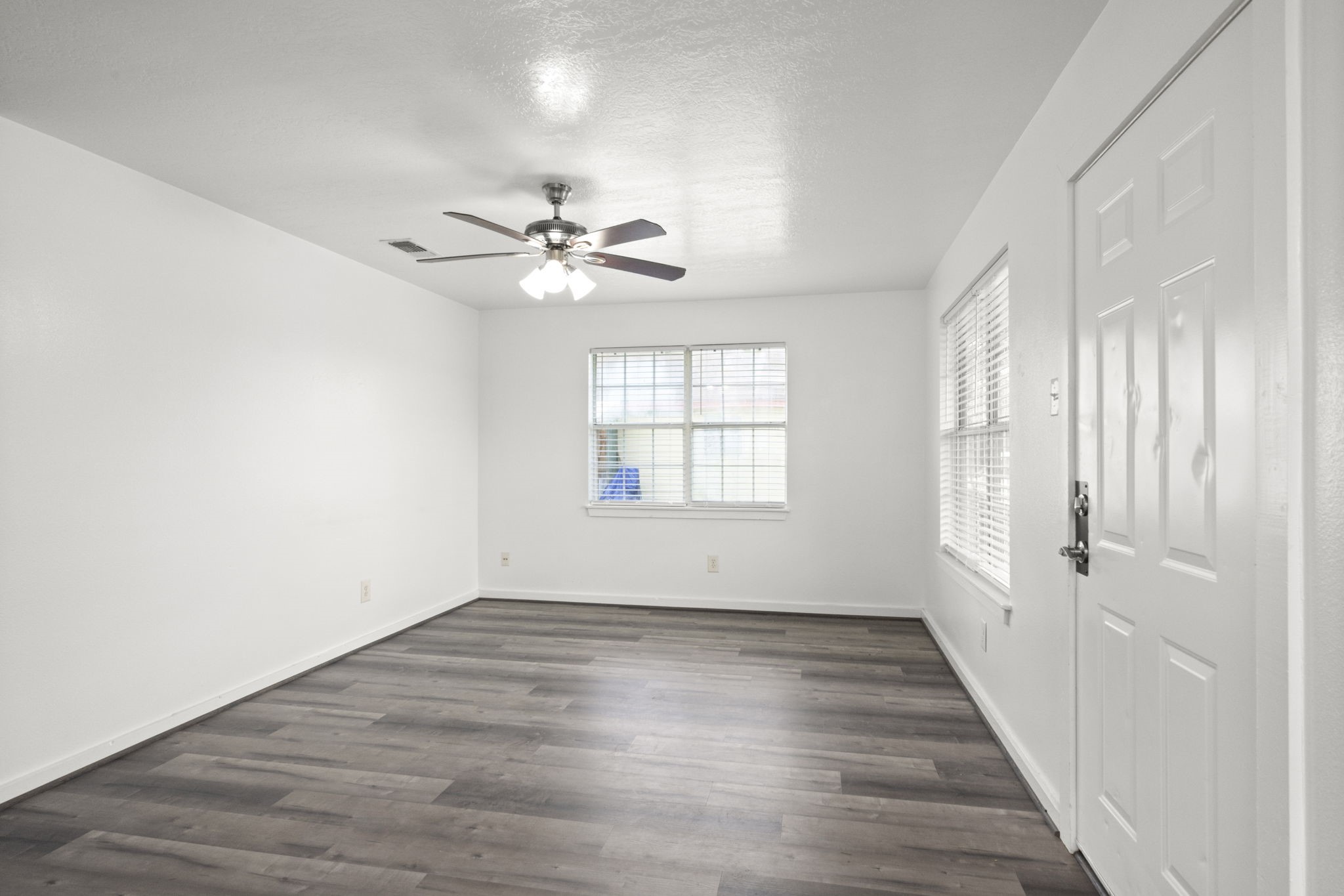 1935 1st Street Hempstead, TX 77445 - Photo 13 of 29 wooden floor in an empty room with a window