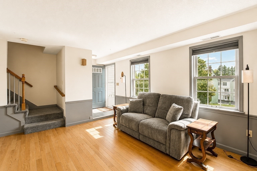 53 Century Way, Unit 53 Gardner, MA 01440 - Photo 3 of 22 a living room with furniture and a large window