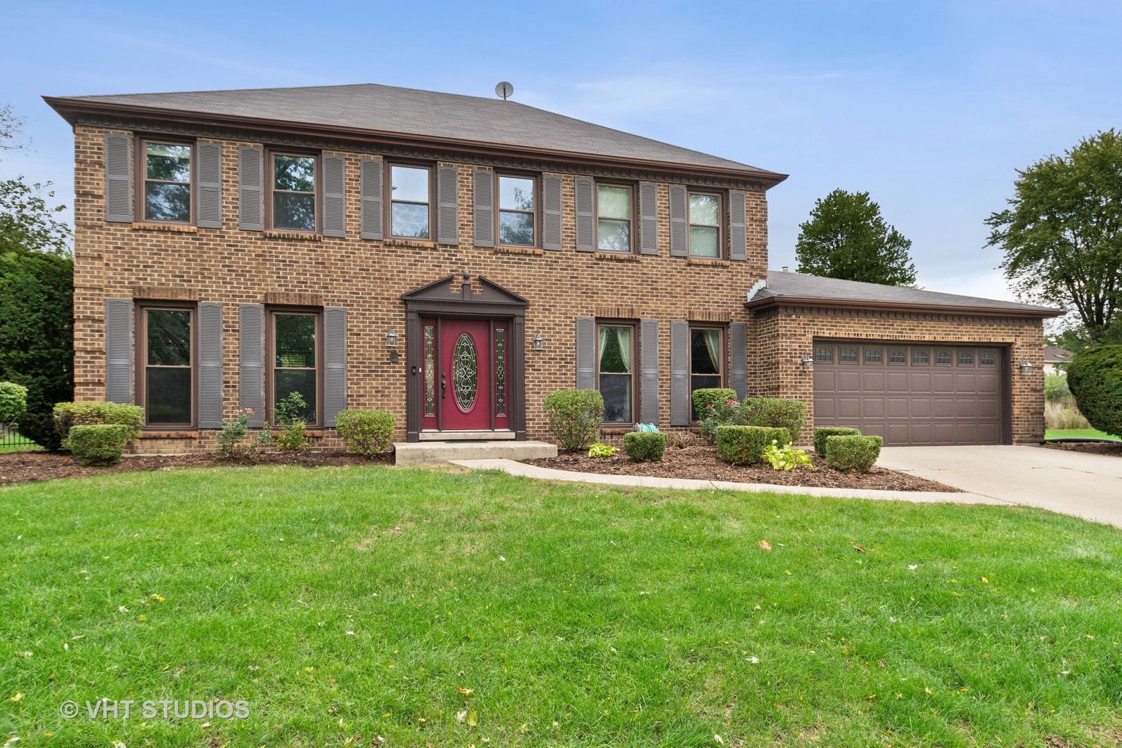 a front view of a house with a yard and garage