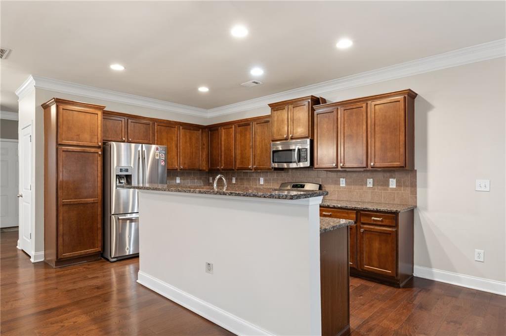 3803 Manor View Alpharetta, GA 30004 - Photo 16 of 33 a kitchen with stainless steel appliances granite countertop a refrigerator and a stove top oven