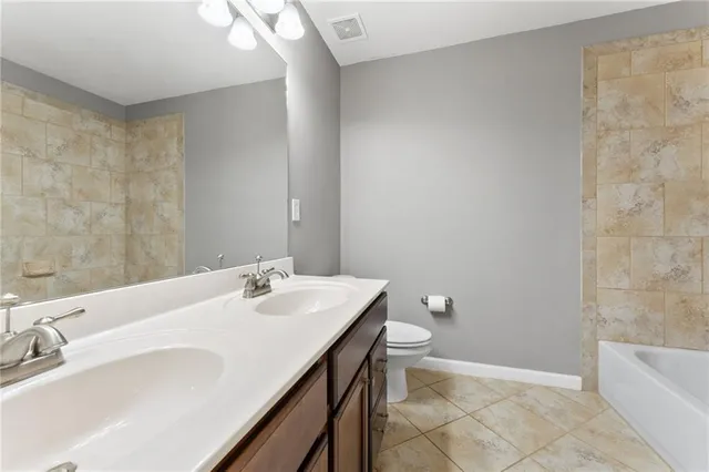 a bathroom with a sink a toilet and bathtub