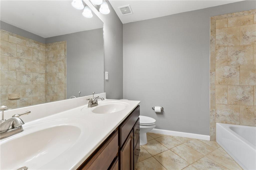 3803 Manor View Alpharetta, GA 30004 - Photo 28 of 33 a bathroom with a sink a toilet and bathtub