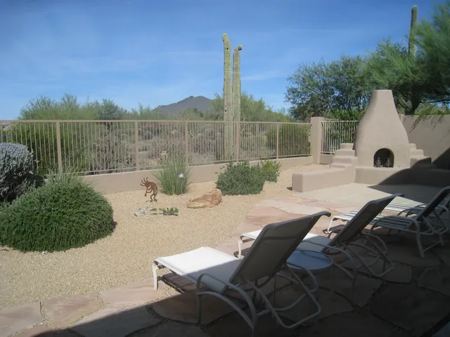 a view of a patio with a table chairs and a potted plants