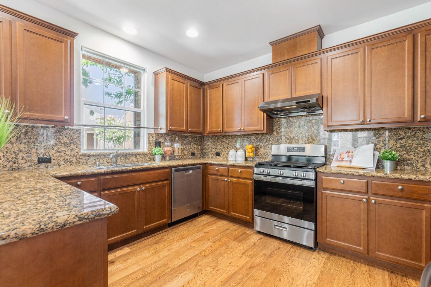4232 Astor Hollow Street San Ramon, CA 94582 - Photo 11 of 37 a kitchen with stainless steel appliances granite countertop a stove a sink and a microwave