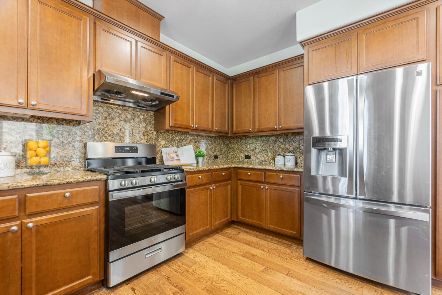 4232 Astor Hollow Street San Ramon, CA 94582 - Photo 12 of 37 a kitchen with granite countertop stainless steel appliances a refrigerator a stove a sink and cabinets