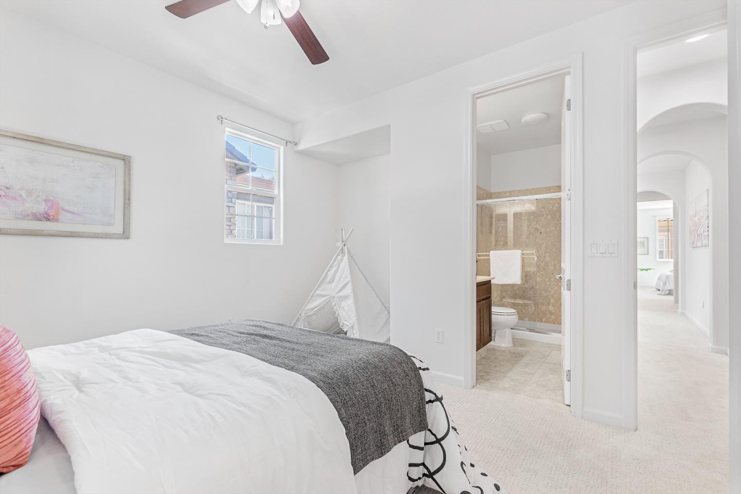 4232 Astor Hollow Street San Ramon, CA 94582 - Photo 24 of 37 a bedroom with a bed and a chandelier