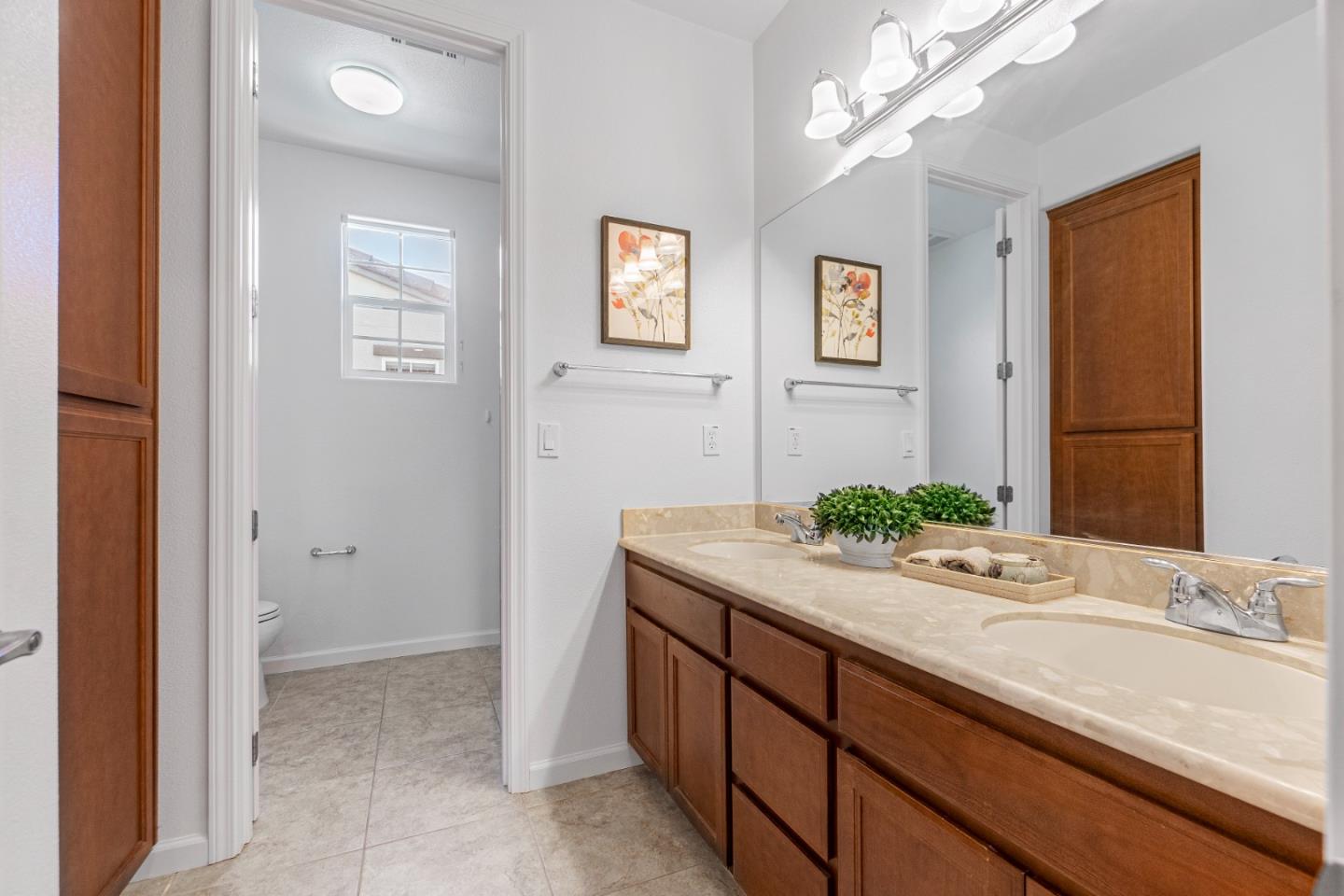 4232 Astor Hollow Street San Ramon, CA 94582 - Photo 31 of 37 a bathroom with a granite countertop sink and a mirror