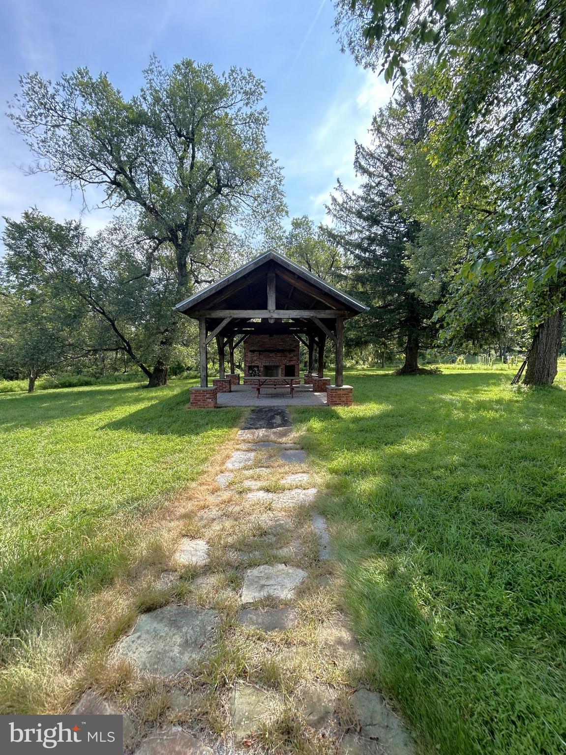 14301 Tower Road Smithsburg, MD 21783 - Photo 111 of 127 a view of a swimming pool with a yard and large trees