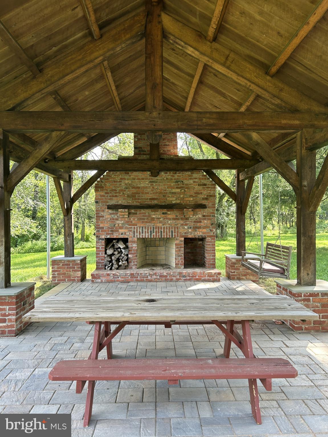 14301 Tower Road Smithsburg, MD 21783 - Photo 113 of 127 a view of a patio with a table and chairs under an umbrella with a small yard