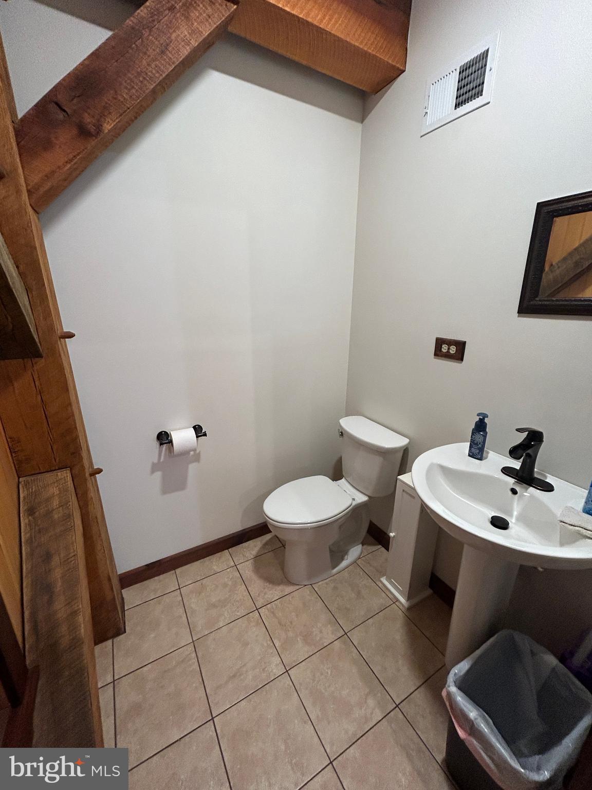 14301 Tower Road Smithsburg, MD 21783 - Photo 33 of 127 a bathroom with a toilet a sink and mirror