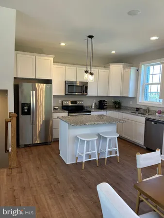 a view of kitchen with granite countertop a stove top oven and a sink