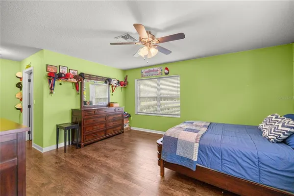 a bedroom with furniture and a flat screen tv