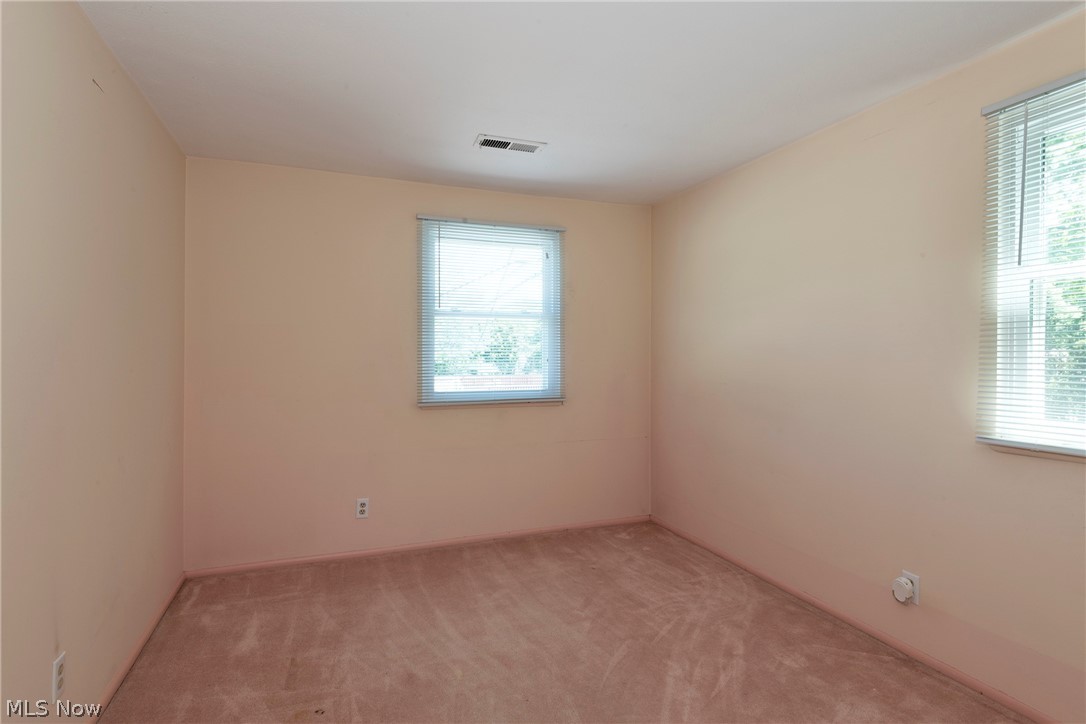6484 State Road Parma, OH 44134 - Photo 24 of 36 Second bedroom featuring two windows that fill the space with natural light.